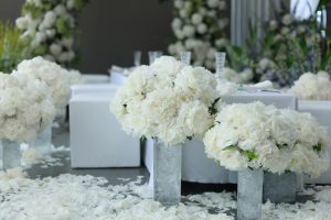 Sophisticated wedding decoration with white floral arrangements and elegant seating.